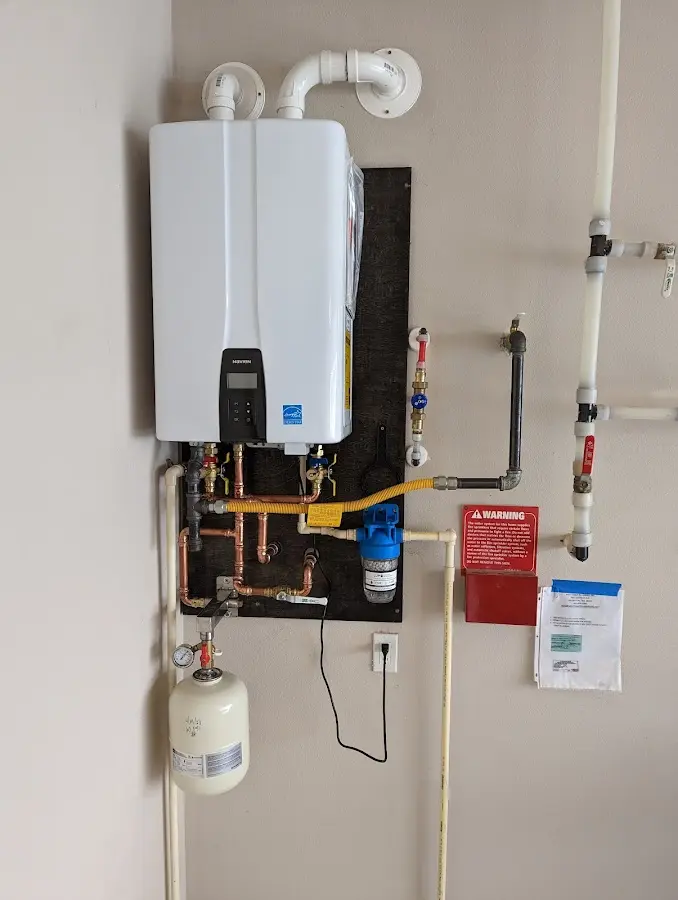 Professional plumber installing copper piping in a Hempfield home